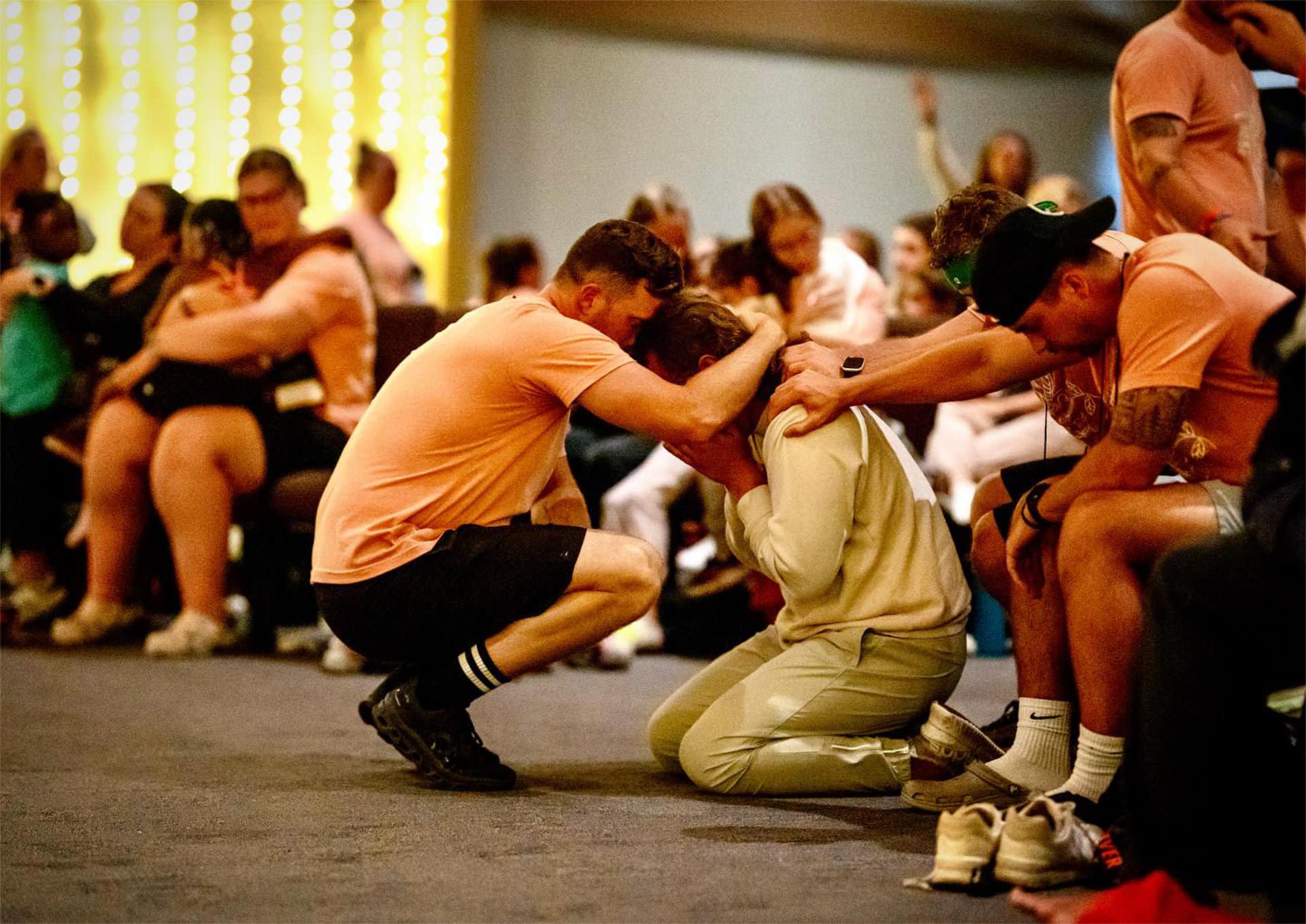 lfac camp counselors praying together in group for participant during emotional camp moment