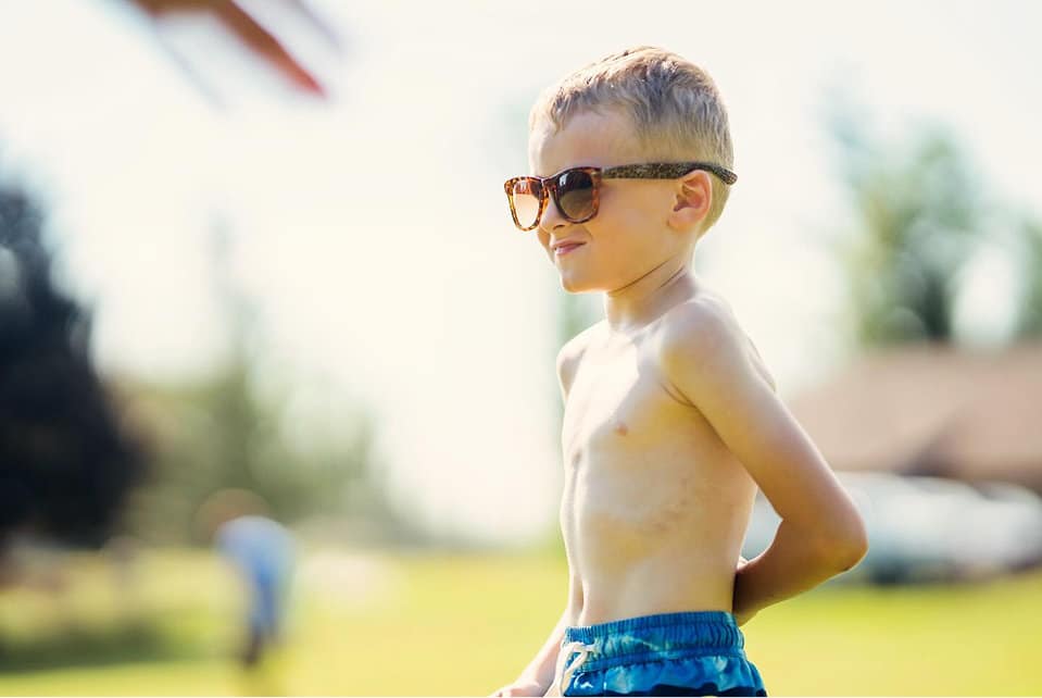 lfac young camper wearing sunglasses smiling confidently on sunny summer day